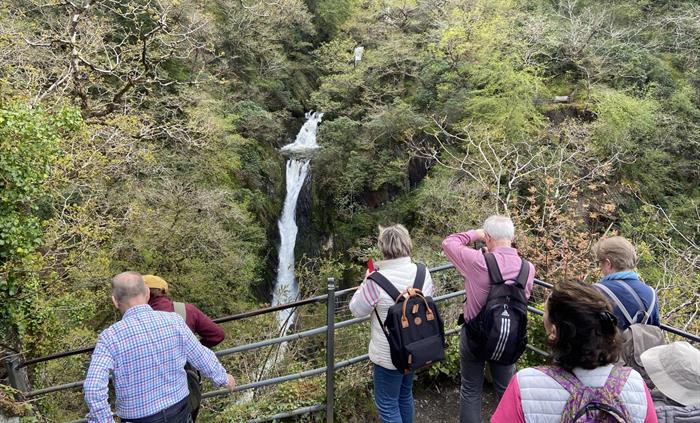 Guests at the bottom of the Devils Bridge Waterfall having climbed down Jacob’s ladder